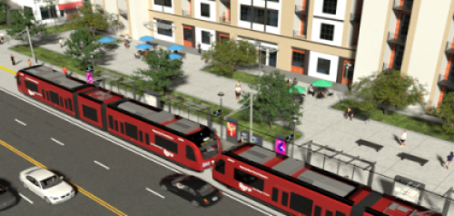 trolley on tracks next to mixed use building and roads
