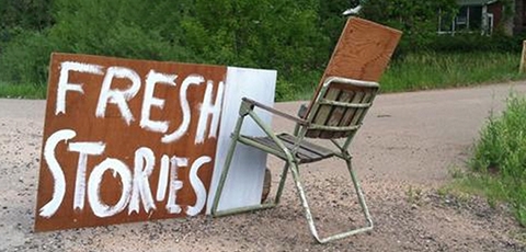 Photo of chair with "Fresh Stories" sign.