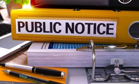 Photo of Yellow Office Folder with Inscription Public Notice on Office Desktop with Office Supplies and Modern Laptop