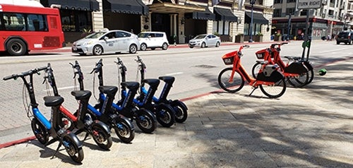 scooters lined up on the street