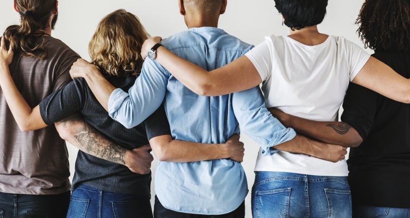 People joining hands over shoulders