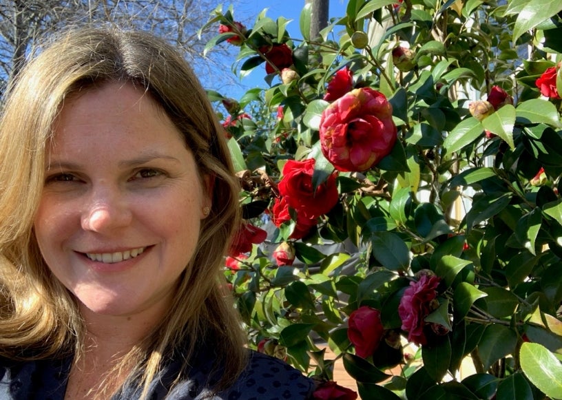 CSO Shelby Busó next to flowers