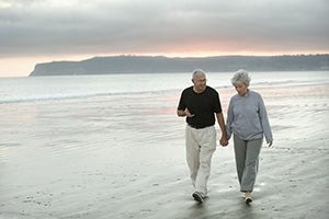 Photo of Mature Couple Walking on the Beach