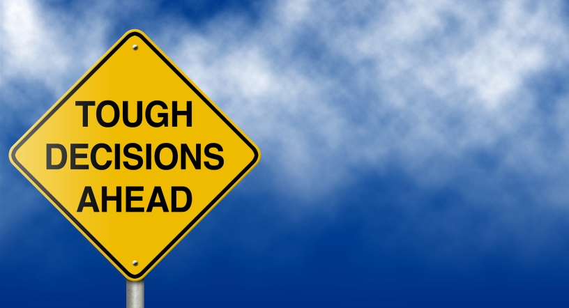 Road sign: Tough Decisions Ahead