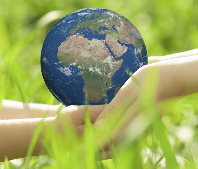 Two hands holding a model of earth