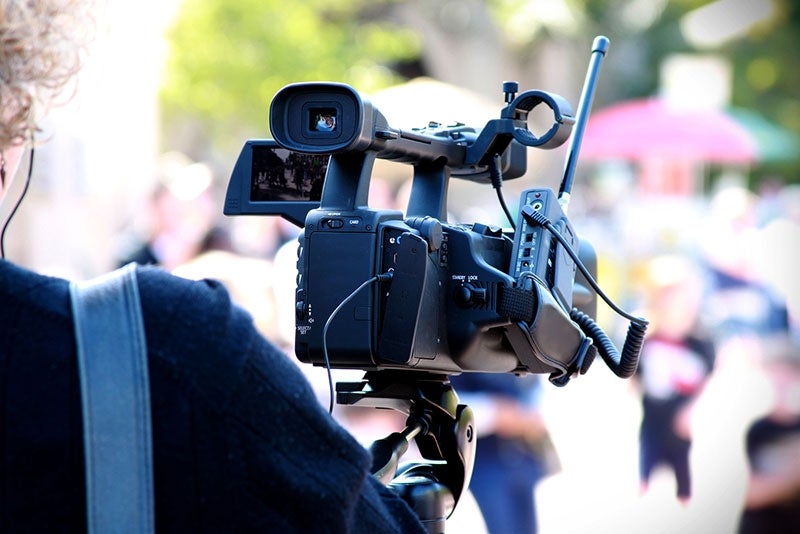 Person filming the crowd at Balboa Park