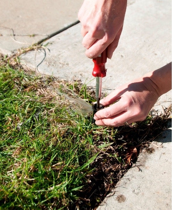 Man fixing a lawn sprinkler