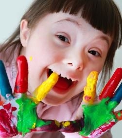 Smiling girl with painted hands