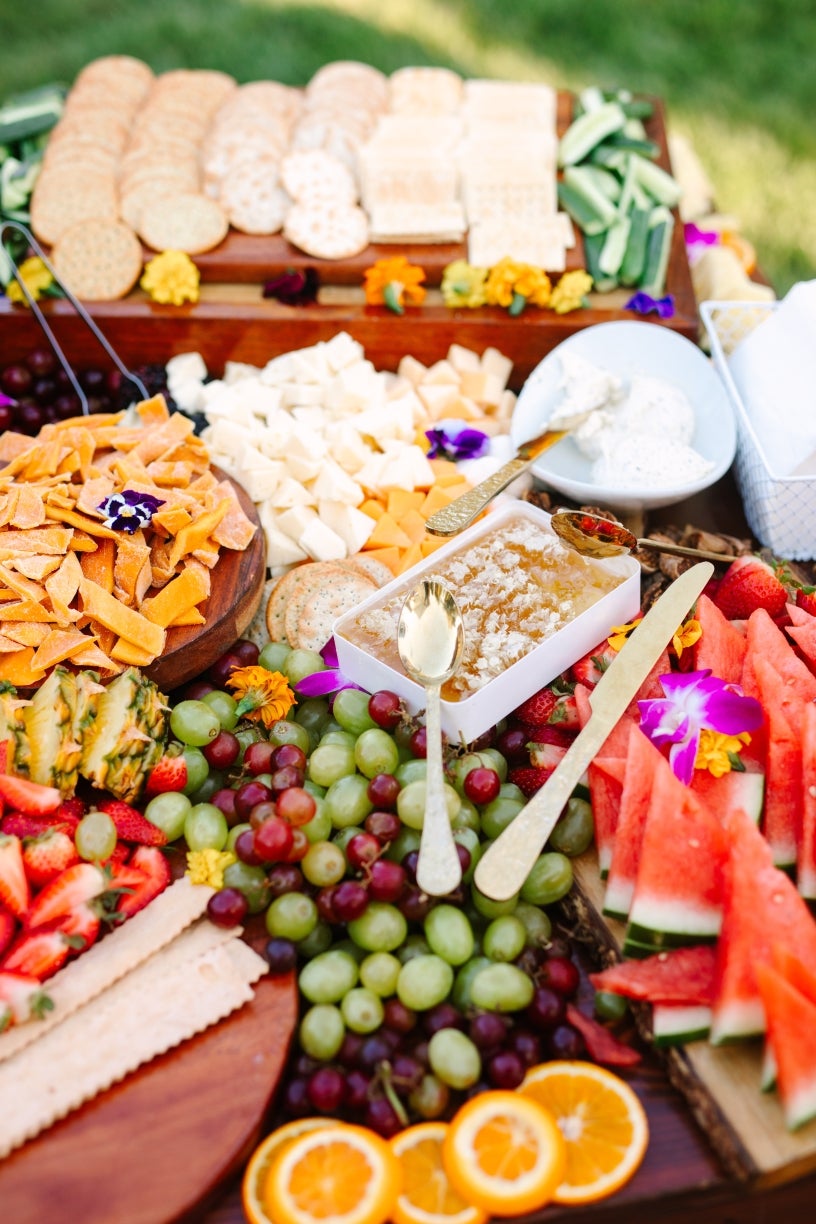 Photo of a "Grazing Station" filled with an assortment of cheeses and fruits