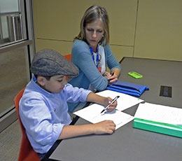 Librarian Jayne Henn helps Edward Ruiz in the Union Bank Homework Center.