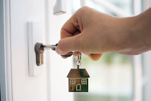 Man unlocks the door of new home with a key