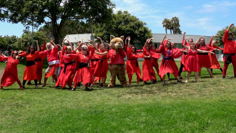 People posing in red dresses