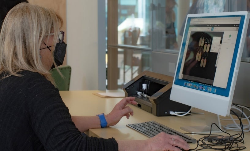 Person in makerspace working on a computer