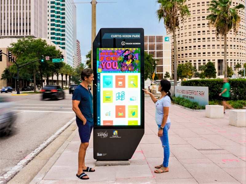 two people standing in front of kiosk