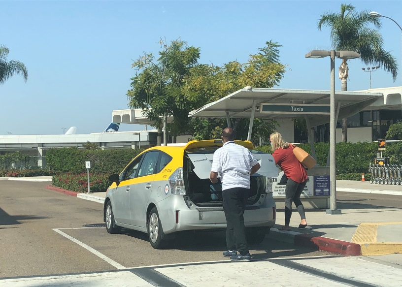 Taxi accepting a fare at the airport