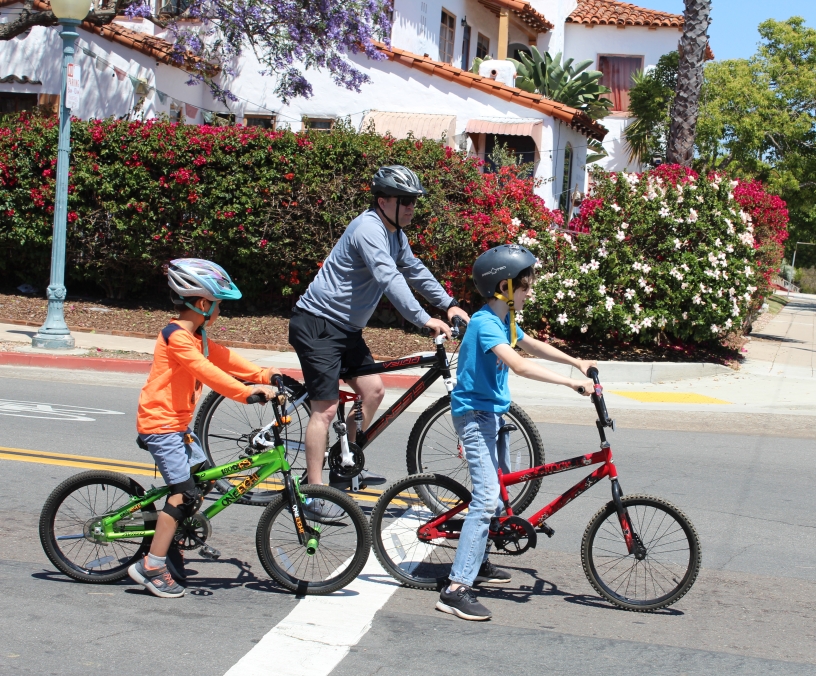 Two kids and one adult on bicycles