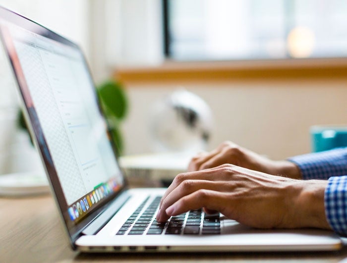 Person working on a laptop computer