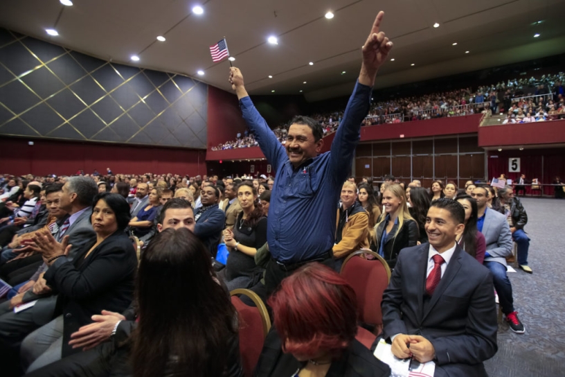 man celebrating during naturalization ceremony