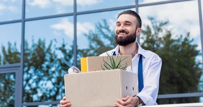 Man Quitting Work with Box