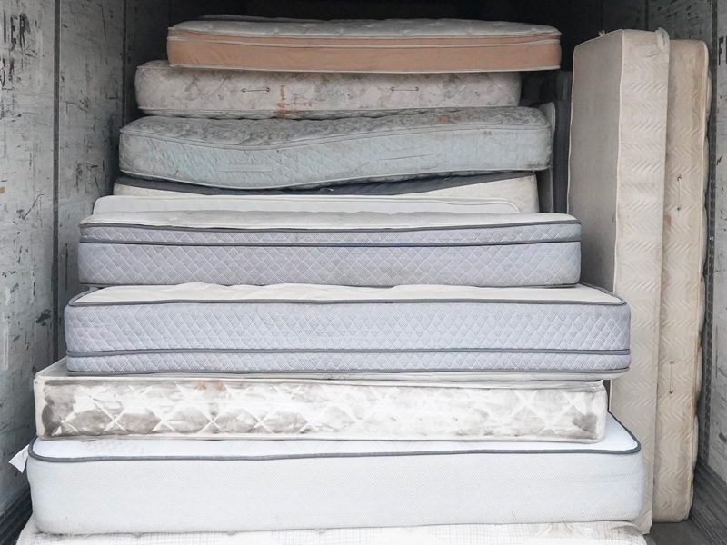 a stack of donated mattresses
