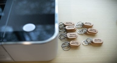 Glowforge with wooden laser cut keychains alongside