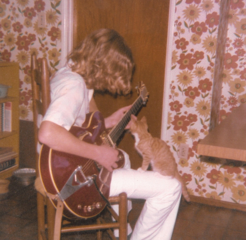 Sepia photo of kid and guitar