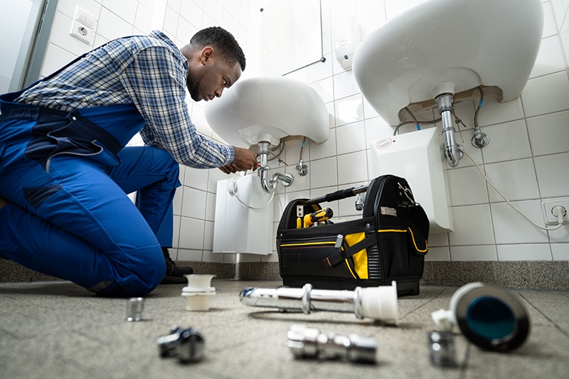 a plumber working on sink repairs