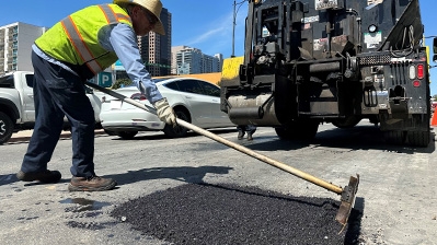 City worker fixing pothole