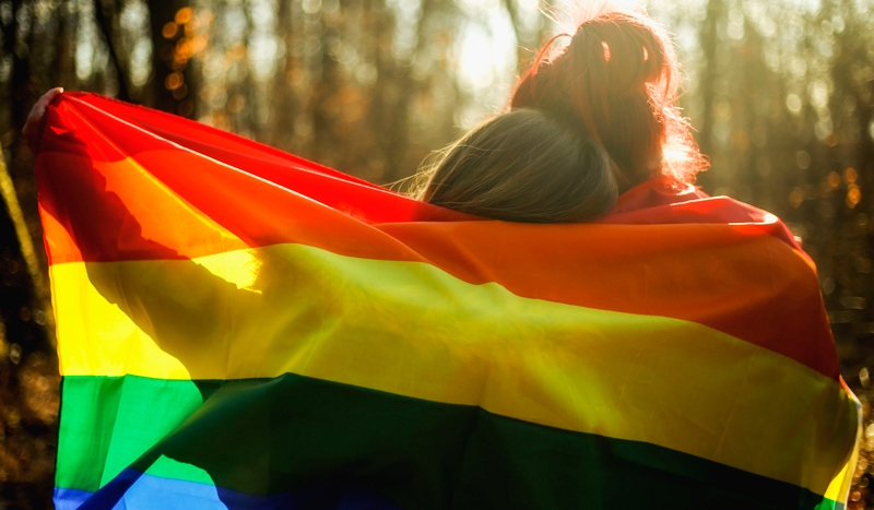 Rainbow flag wrapping around two people
