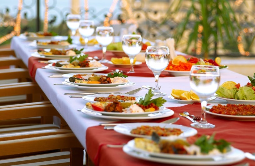 Table of 12 set for an event with full place settings.