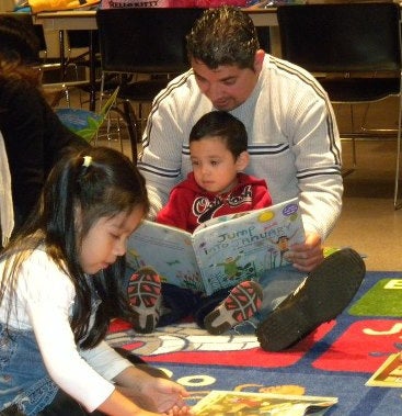 Israel Sr & Israel Jr & Janet reading Jump into January.