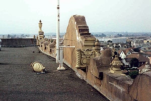 A n unsupported, decorative precast concrete element on a roof building.