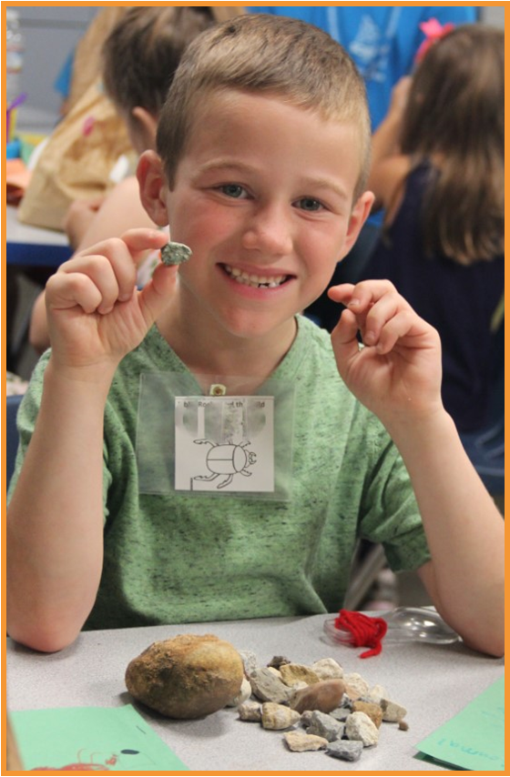 Child holding small rock