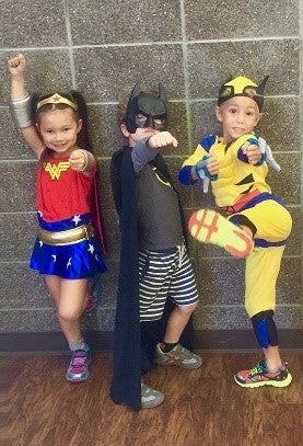 Kids in superhero costumes