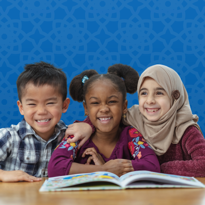 Children smiling with an open book