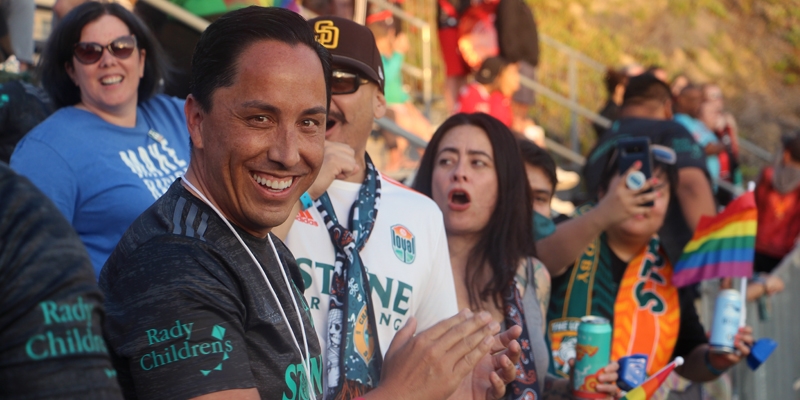 Mayor Todd Gloria cheering in the stands at an event