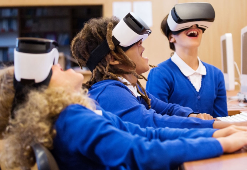 Three kids wearing virtual reality goggle