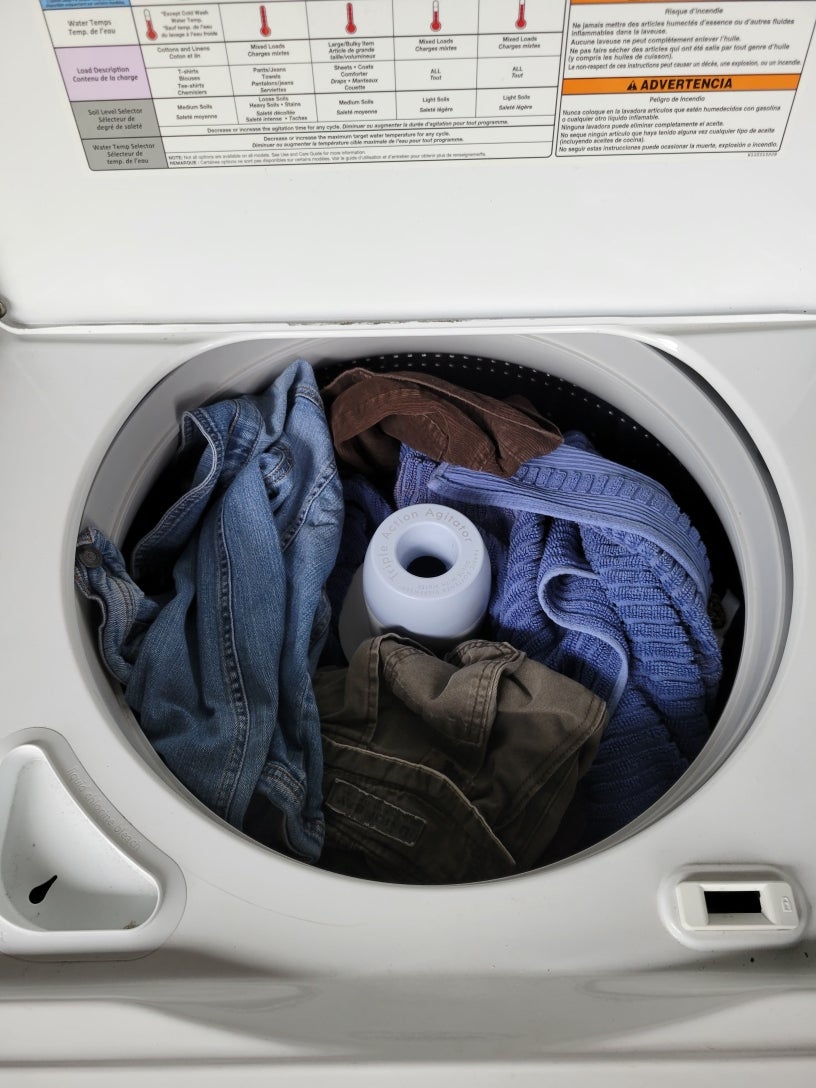 top loading washing machine full of clothes