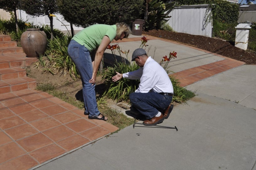 City worker showing a resident how to save water in her yard