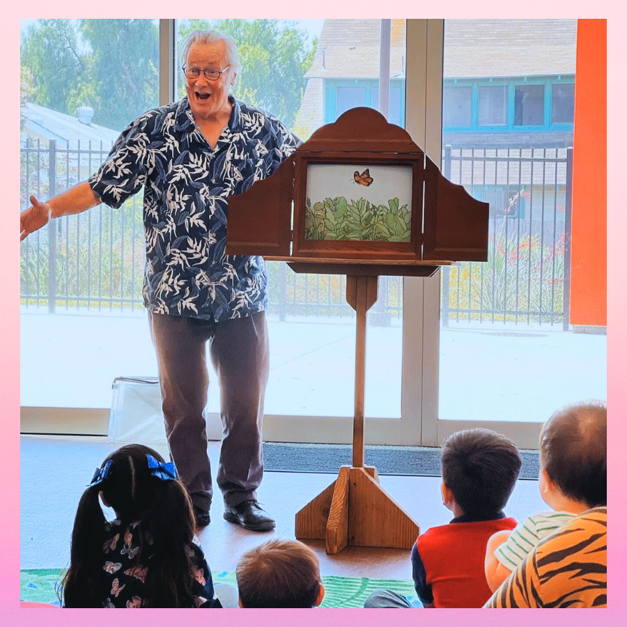 A group of children listen to Kamishibai storytime, a traditional Japanese storytelling performance.