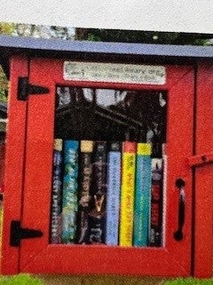 Little Free Library station painted red.