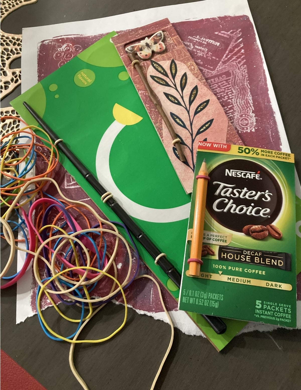 Scrap paper, rubber bands, and pencils for making a journal.