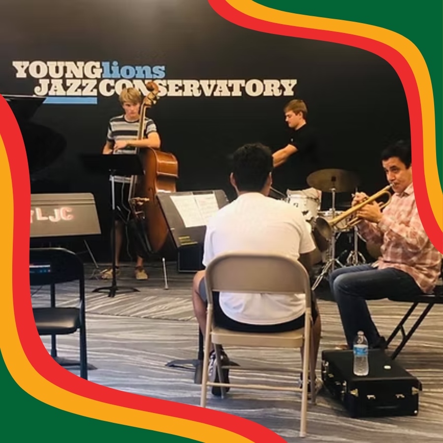 Photograph of young students, two are seated and playing the flute and one is standing to play the bass.