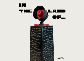 Black obelisk covered with censored words. A black and red loudspeaker sits on top. Artwork by Cindy Zimmerman. Title-Monument.