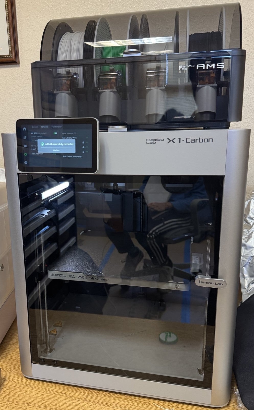 A picture of a Bambu 3D printer on a table.