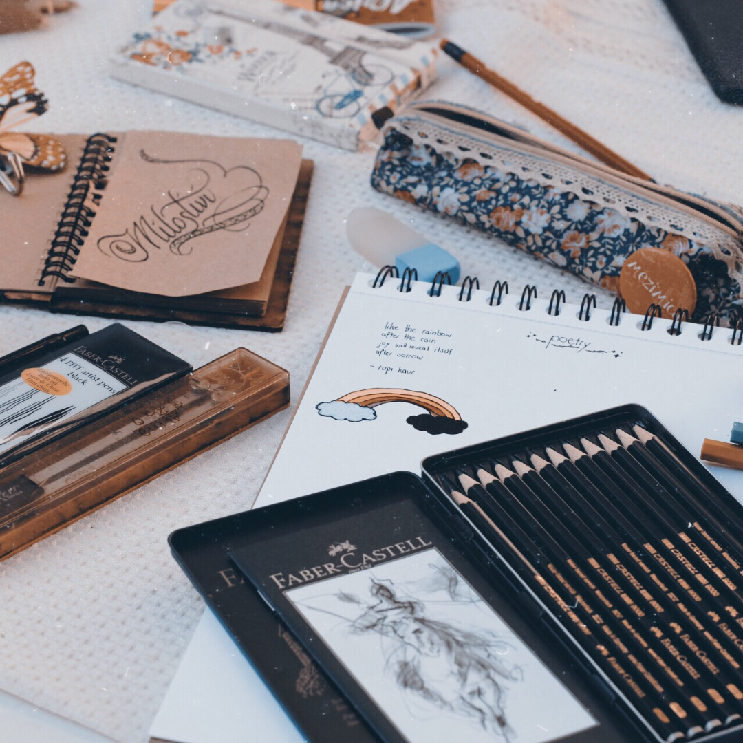 Top-down view of a person’s hand as they draw a comic.