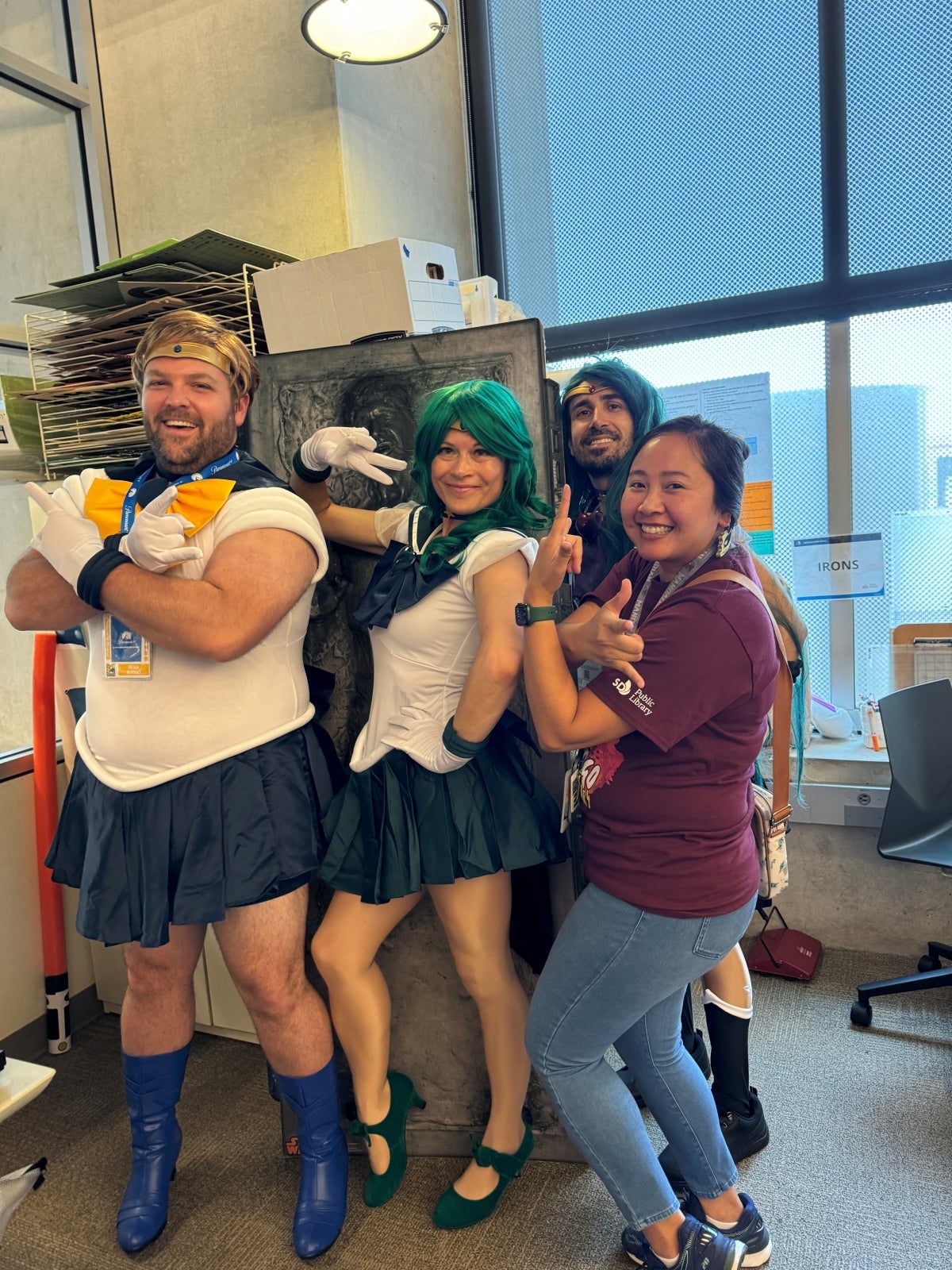 People dressed in Salor Moon costumes posing in a group.