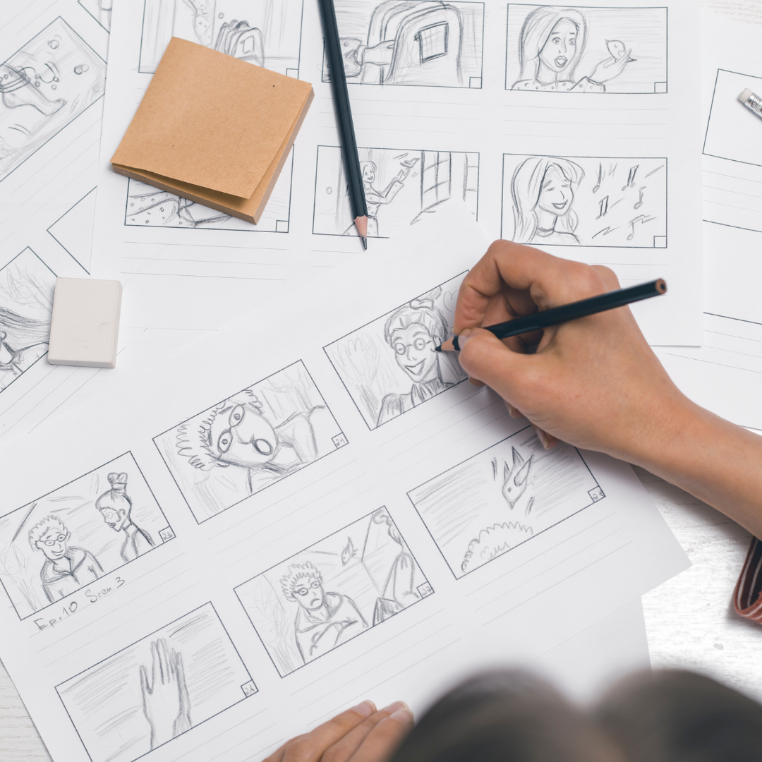 Top-down view of a person’s hand as they draw a comic.