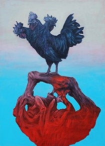 Black rooster standing on a bundle of branches