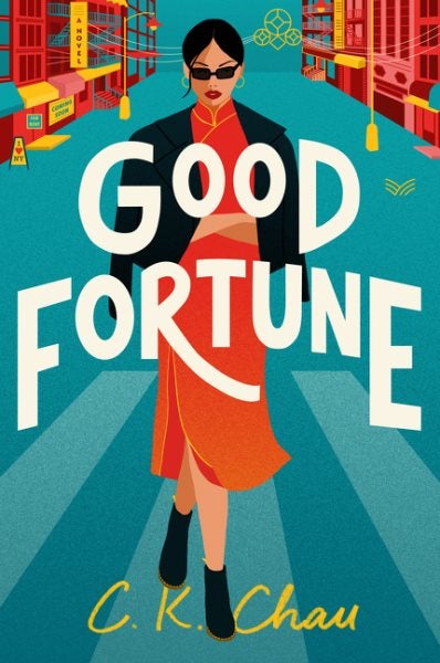 An illustrated image of a woman wearing an orange dress, black jacket and boots, stands in a crosswalk with buildings to her right and left. The background is teal. The words “Good Fortune” are superimposed in bold white letters. The author’s name, C.K. Chau, is in small yellow letters at the woman’s feet.